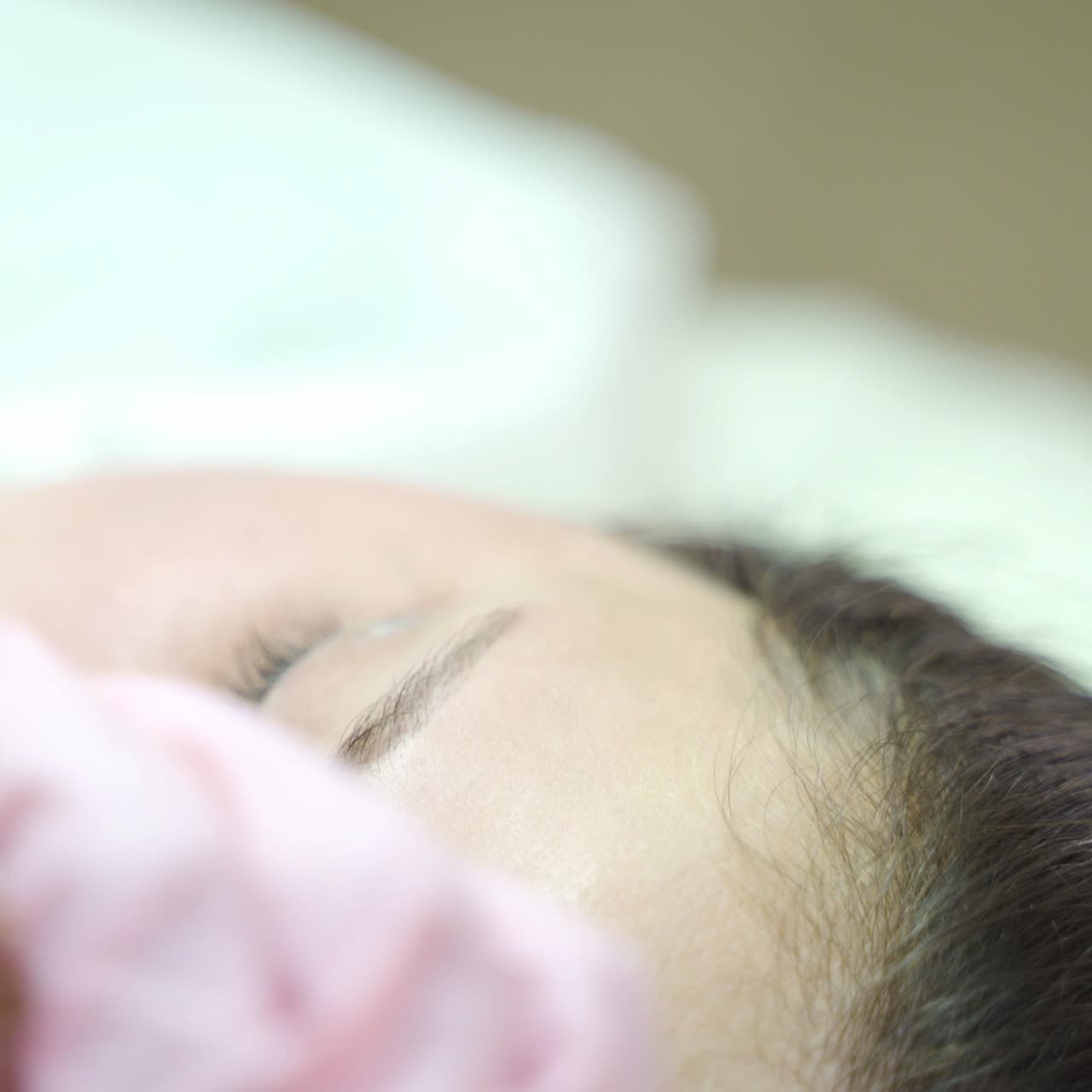 a cosmetologist is making eyebrow staining with a professional needle for permanent eyebrow makeup. Modern cosmetology methods