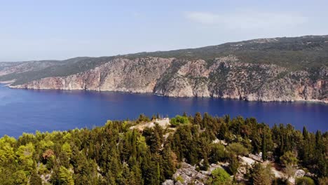 aerial view of venetian castle of assos on high rocky hill overlooking peninsula in the island of kefalonia in western greece