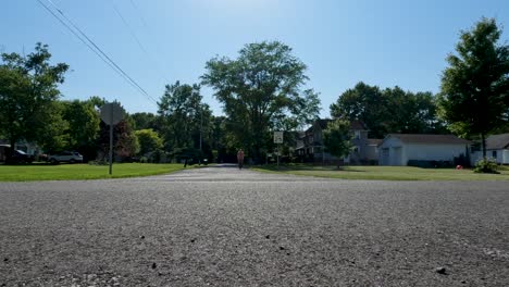 Man-on-day-off-riding-bicycle-on-asphalt-in-sunny-day