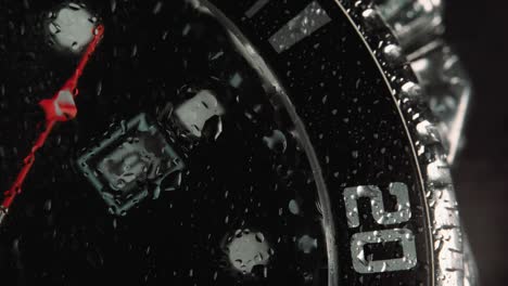 mens japanese chronograph made metal with sapphire glass. wrist watch - slow motion, time passing slowly - beautiful macro shot with little drops of water on the glass