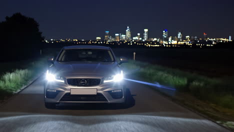 silver car at night on road with city lights