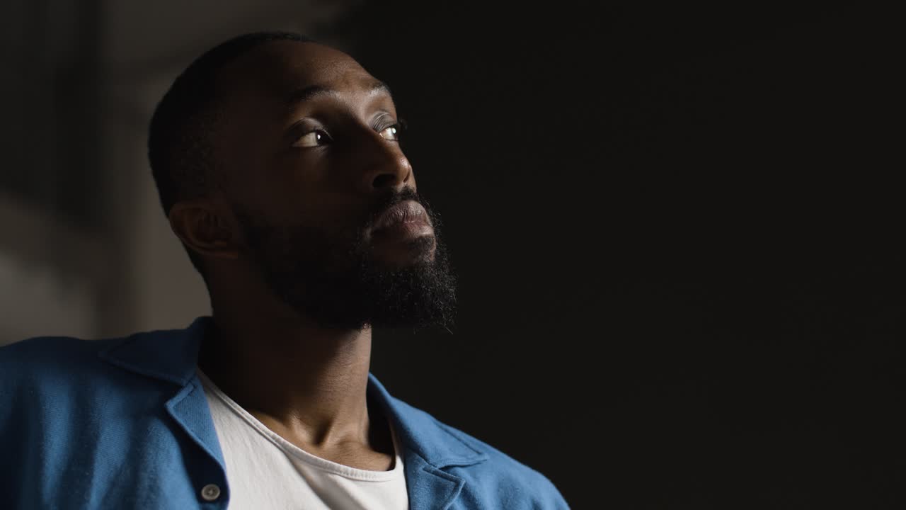 Low Key Portrait Of Serious Man Deep In Thought With Copy Space