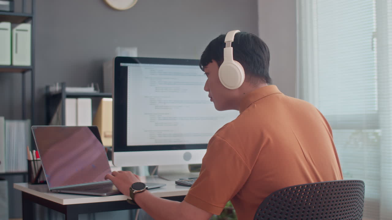 Programmer Developing and Testing Codes on Laptop and Computer