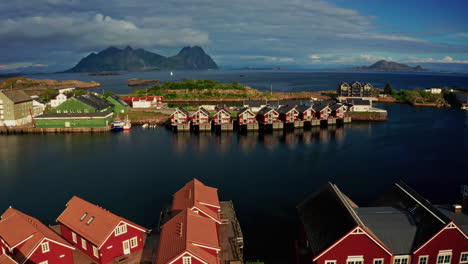 aerial drone shot over svolvaer, lofoten islands, norway.
high view of the fishermen cabins and the scenic nordic landscape at sunset.