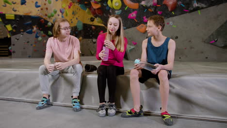 friends resting in a climbing gym