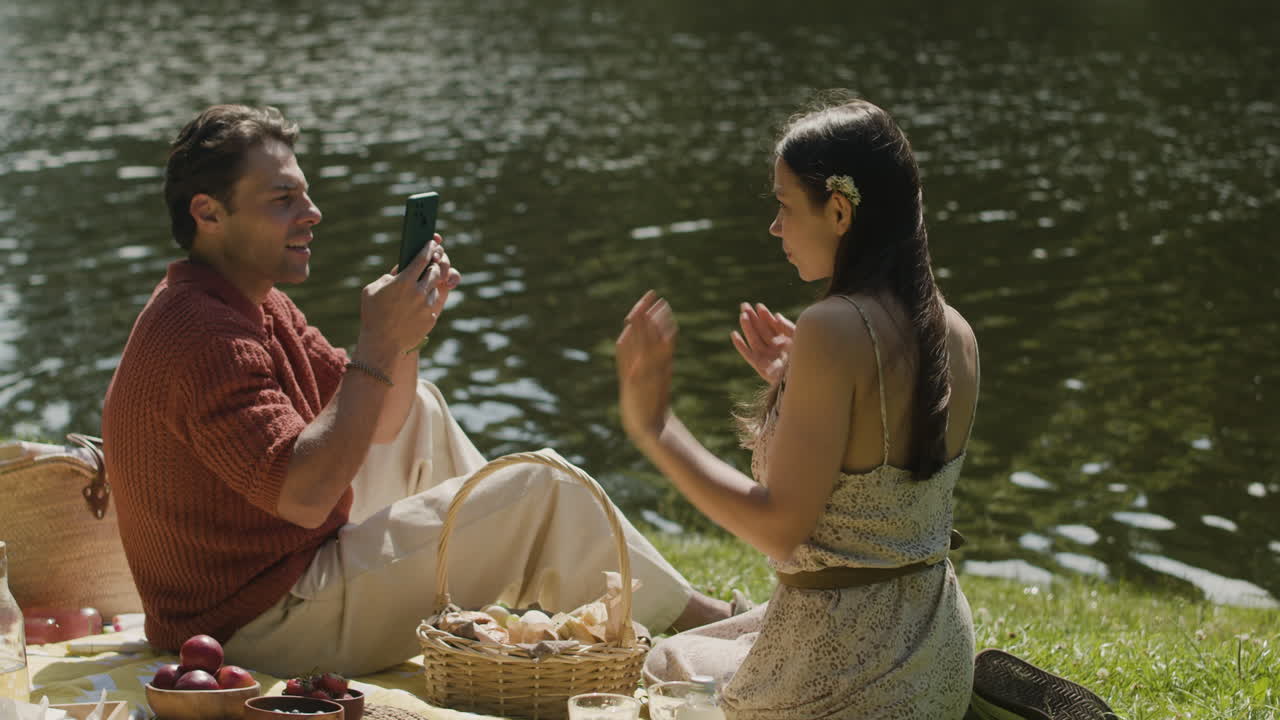 Couple on a picnic by the lake