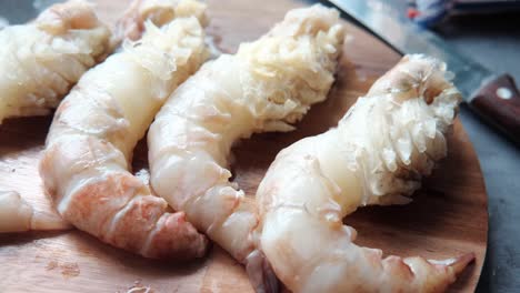 raw shrimp on a wooden cutting board