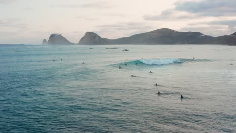 Surfing-at-sunset-at-the-surf-spot-Don-Don-in-Gerupuk,-Lombok