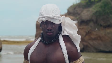 on the beach, a muscular, dark-skinned male cosplayer.