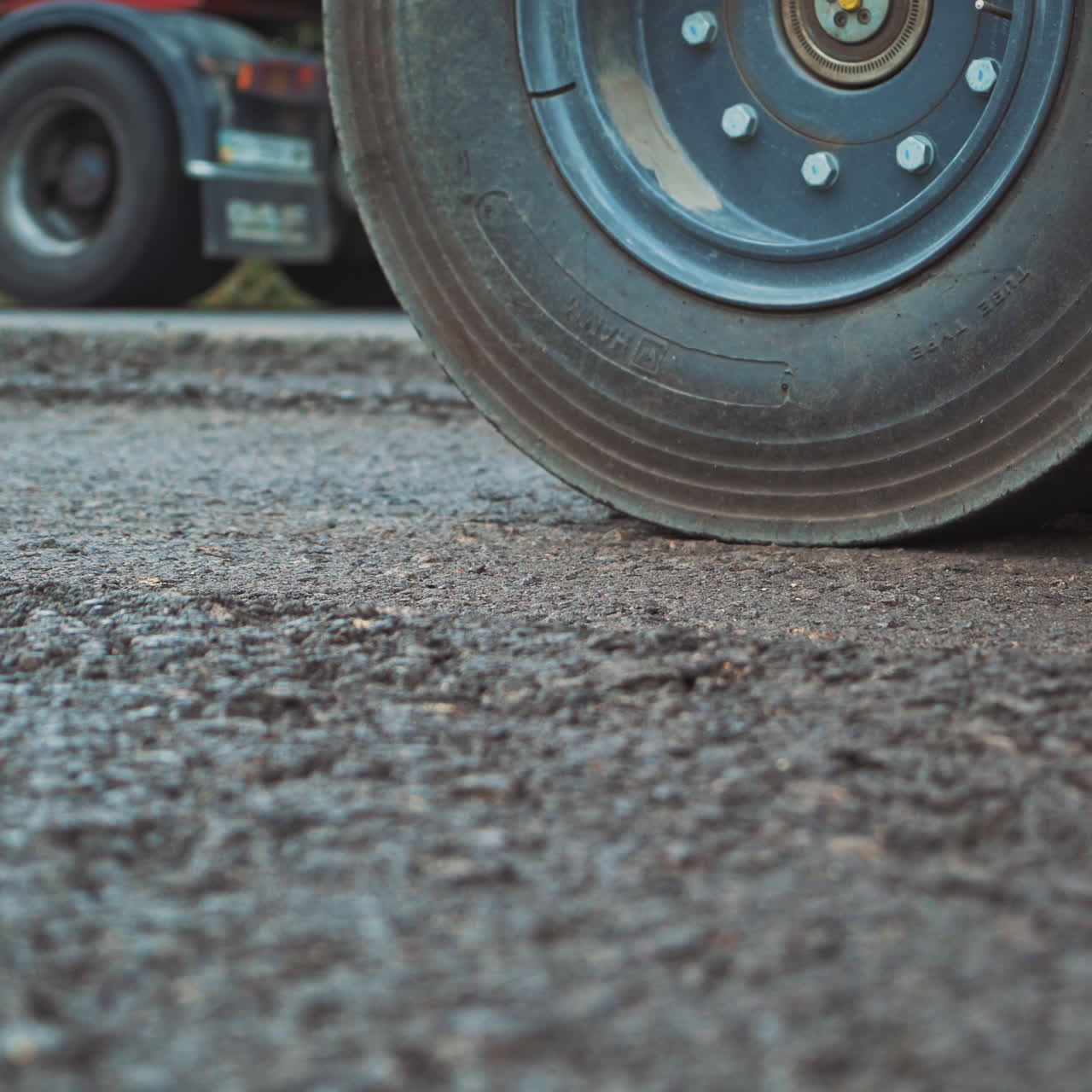 Laying a new asphalt on the road. Road repair machine with heavy vibration roller compactor