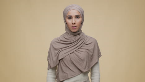 woman in hijab with a serious expression