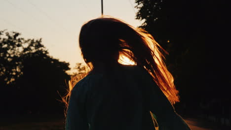 The-Child-Plays-With-His-Long-Hair-In-The-Rays-Of-The-Setting-Sun