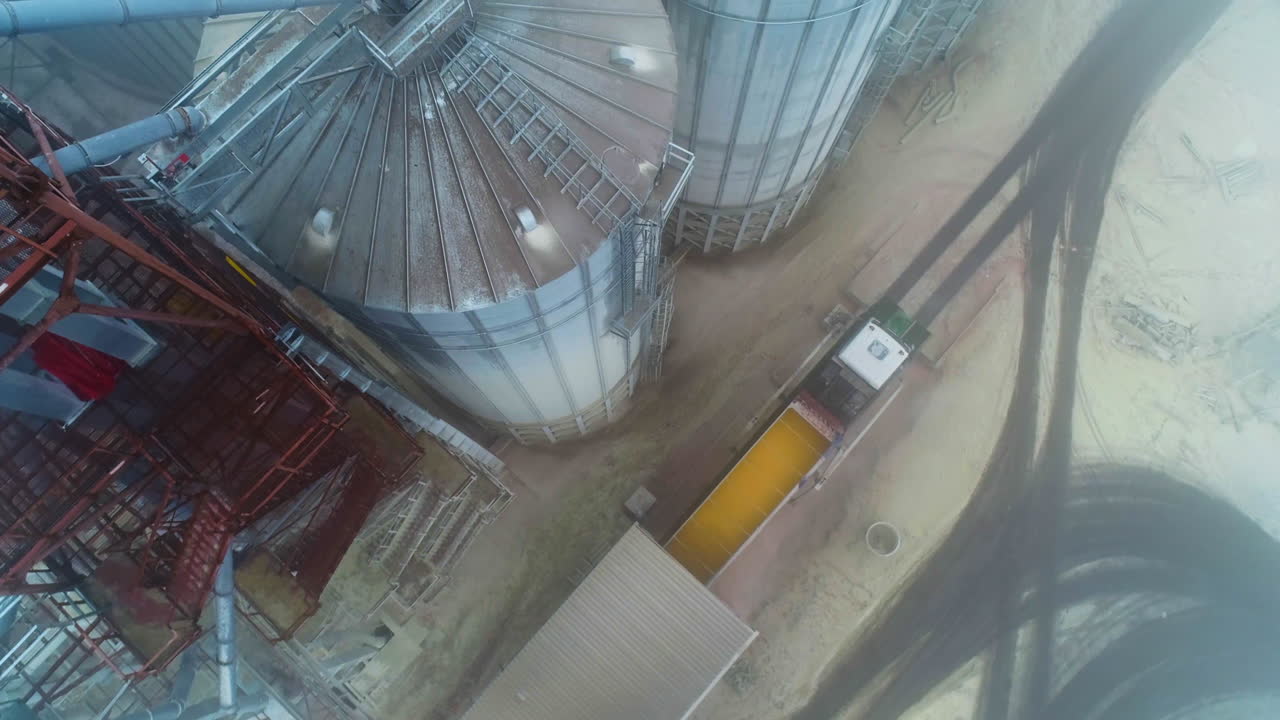 Aerial view of grain silos and a truck unloading grain
