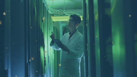 examining data on tablet, scientist in lab coat in green-lit corridor