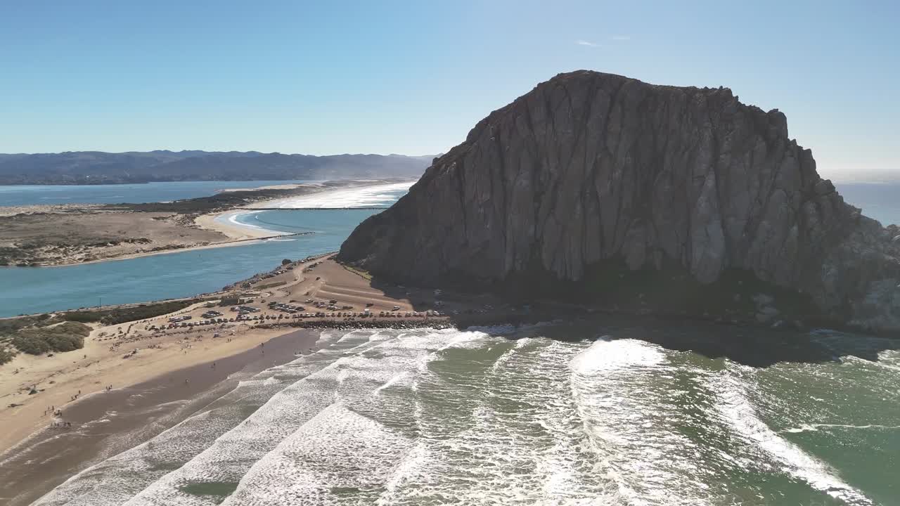 A wide, cinematic panoramic motion scanning the entire coast, harbor, and iconic Morro Rock in one smooth movement