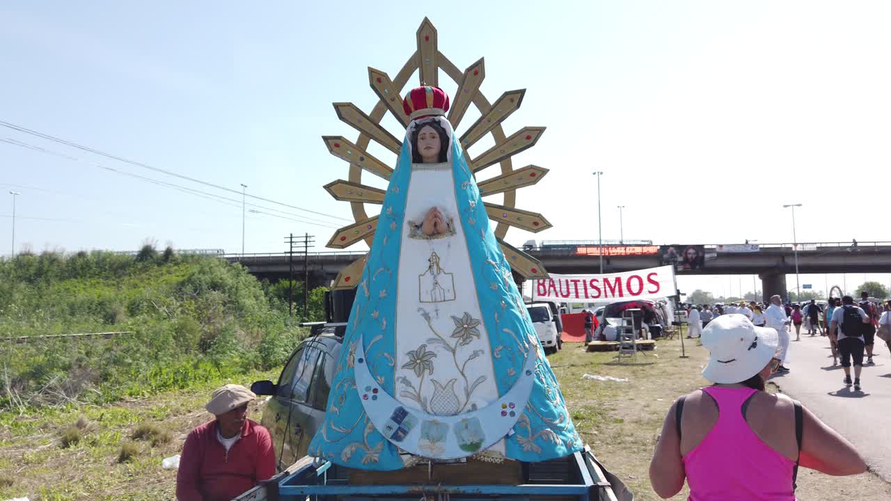 Virgin statue of Immaculate Conception with People processing at Lujan Pilgrimage Argentine Catholic religious praying event outdoors