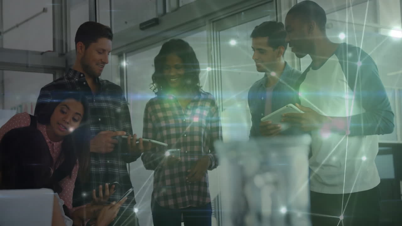 Six professionals collaborating on devices in tech office, featuring glowing network overlay