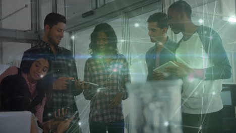 six professionals collaborating on devices in tech office, featuring glowing network overlay
