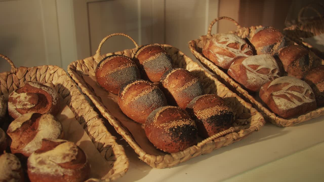 Fresh artesian bread on bakery shop close-up. Bread with black poppy garnish on top and white flour on top. Artisan bread is making by skill bakers using natural and high-quality ingredients. Food with health and flavour benefits.