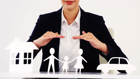 businesswoman with paper cut out of a family