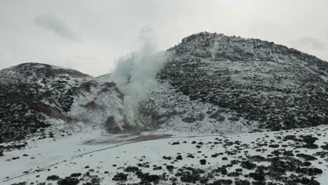 Billowing Steam From Volcanic Vents Of Snowy Mount Io In Winter. Akan Volcanic Complex Of Hokkaido, Japan. wide shot