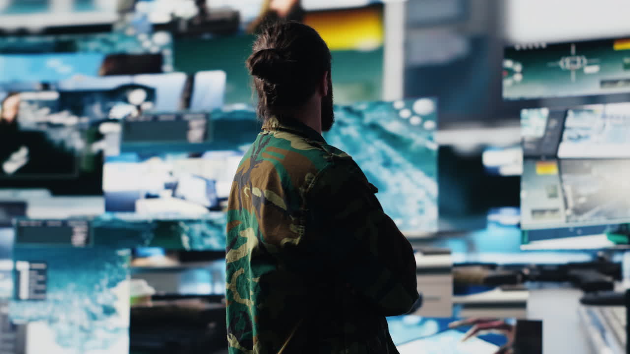 Young soldier working in command center with satellite surveillance