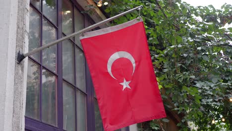 turkish flag hanging from a building window