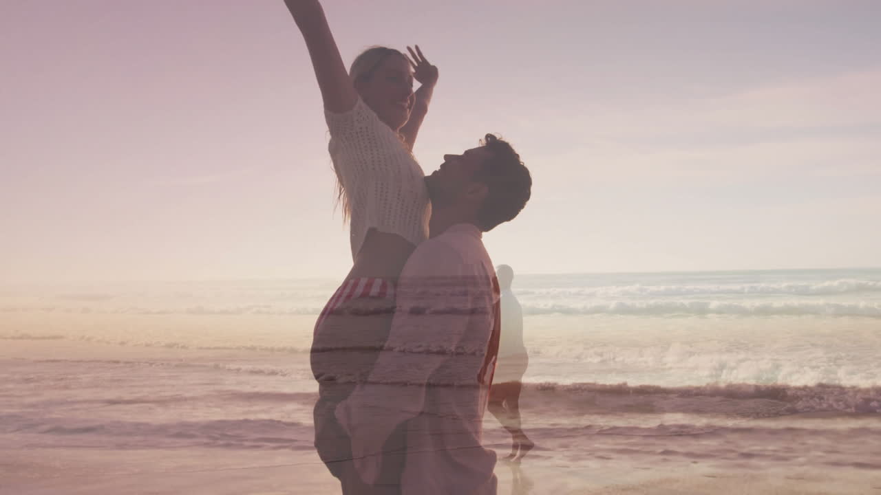Pregnant woman getting lifted by partner on beach sunset, with animated health chart overlay