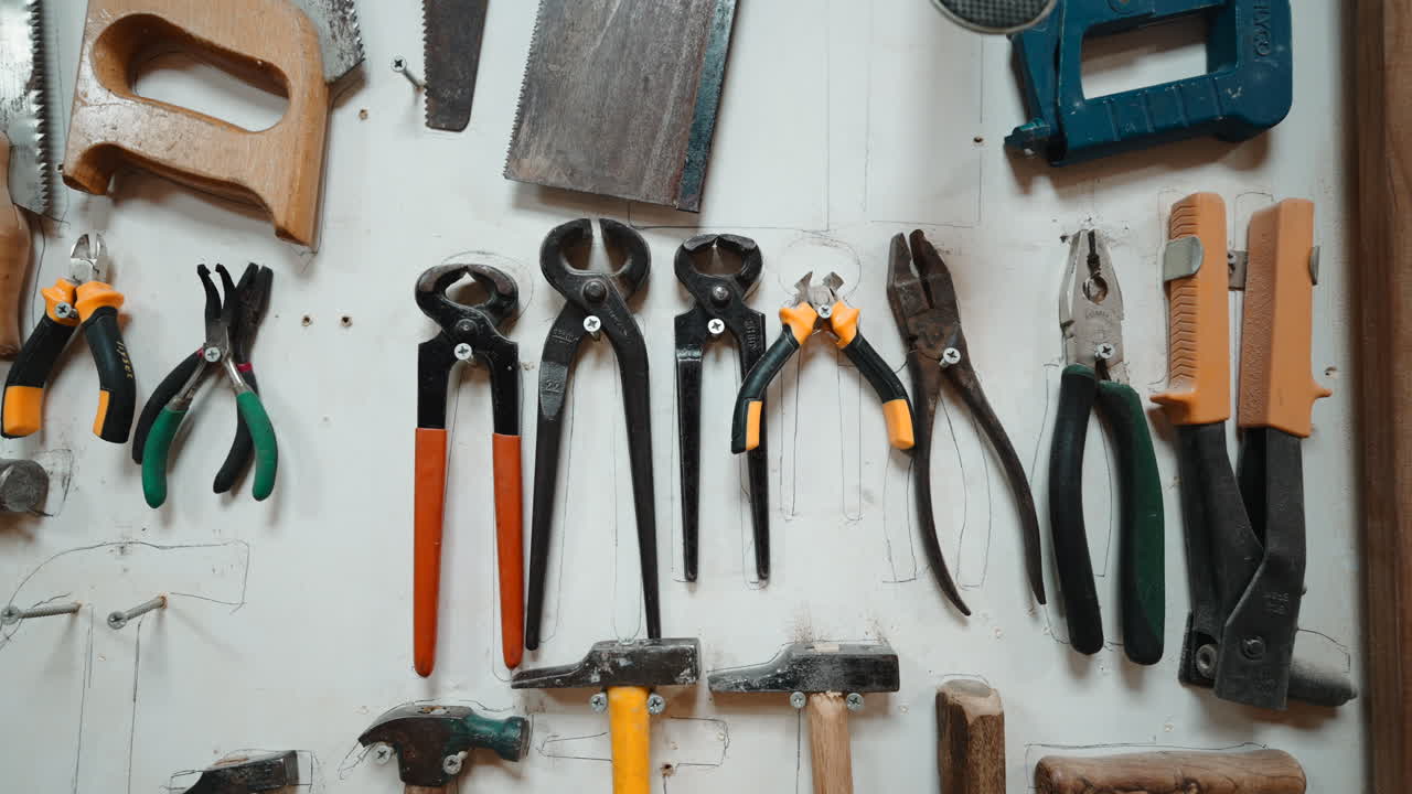Various Hand Tools Hanging Neatly on a Workshop Wall