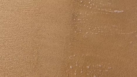 waves gently wash over sandy beach in phuket, thailand, creating a serene and calming atmosphere