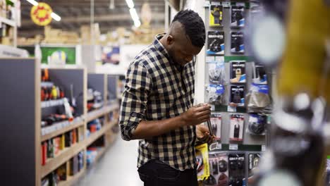 male buyer selecting drill accessories in building and repair shot