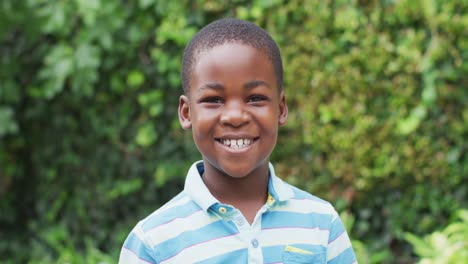 Animation-of-happy-african-american-boy-looking-at-camera-in-garden