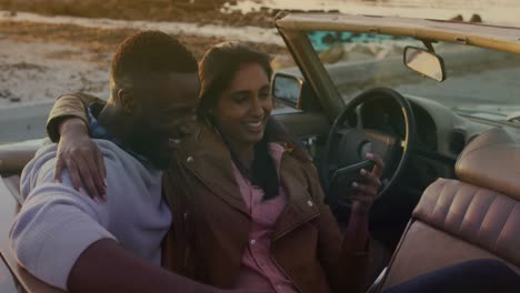 animation of happy diverse couple taking selfie in cabriolet