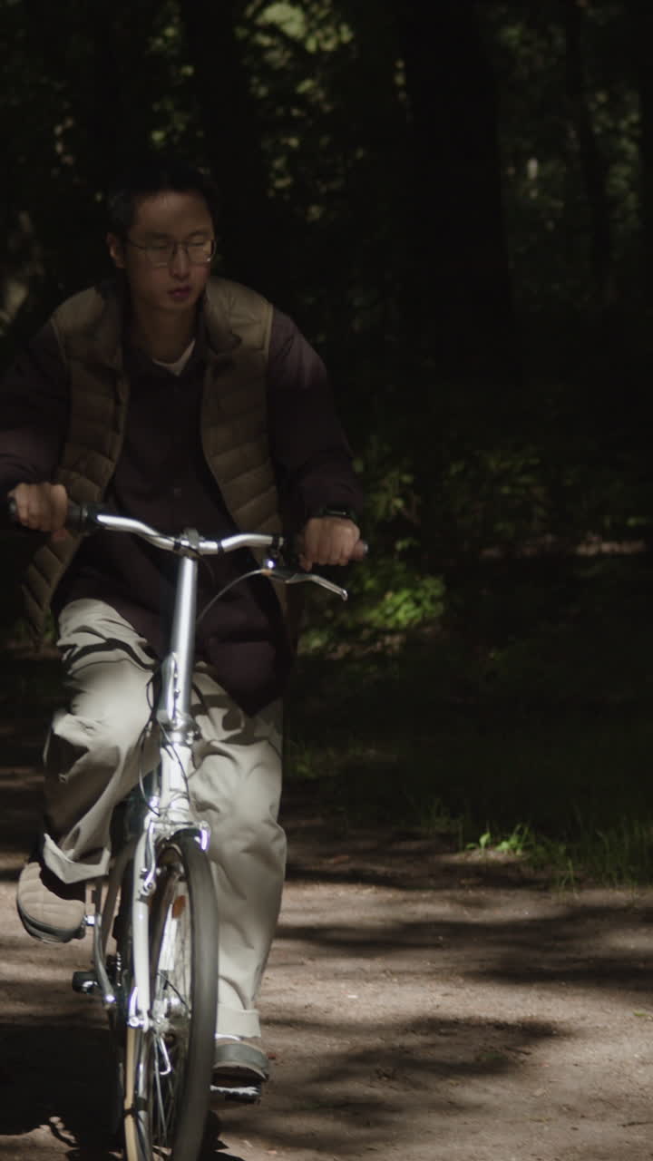 Man riding a bicycle in a forest