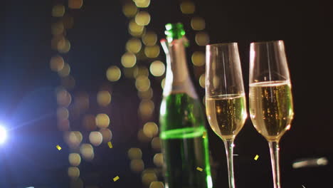 champagne bottle and glasses with golden bokeh lights animation in background