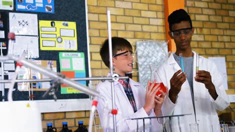 Attentive-school-kids-doing-a-chemical-experiment-in-laboratory