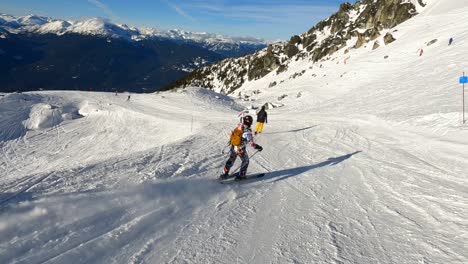 alpine skiing and snowboarding at whistler blackcomb ski resort on a sunny winter day in canada. - pov shot
