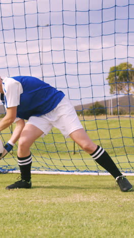 goalkeeper in blue making a save