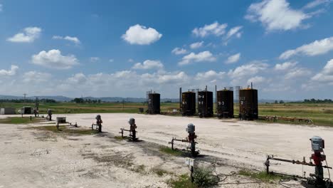 oil deposit tanks on a field in rural lands