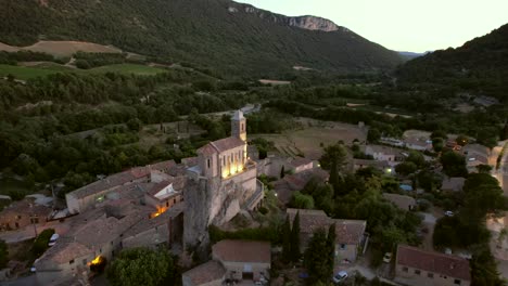 the chapel notre-dame de la consolation, built in 1894 atop a rocky spur overlooking a village in pierrelongue