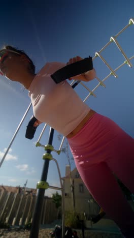 woman doing outdoor workout with resistance band