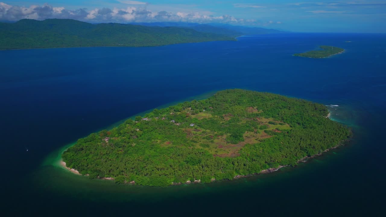 Yuo Island remote pristine untouched tropical Mushi island coastline village Wewak Madang Cape Wom Papua New Guinea aerial drone PNG dry season summer morning bleu sky power fishing boat backwards