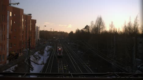 slightly defocused background, morning train on tracks passes below