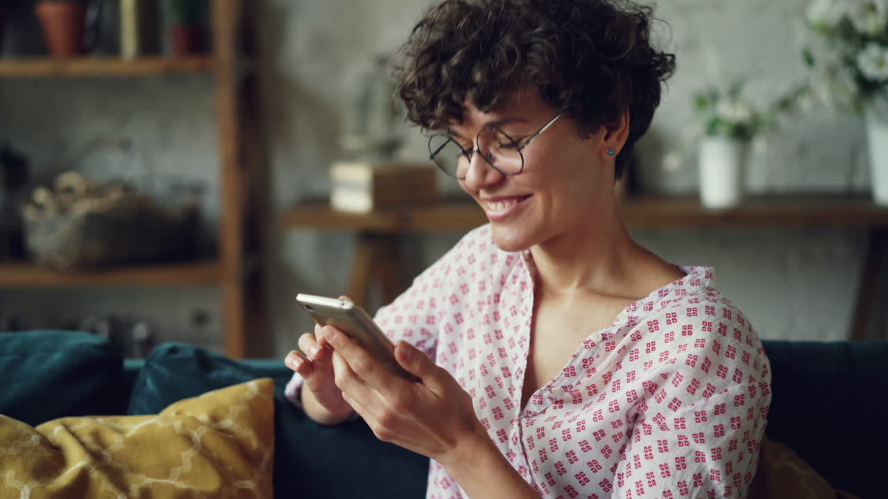 Woman using phone on couch