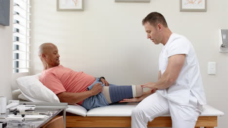 physical therapist adjusting prosthetic leg for patient in medical clinic