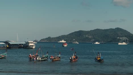 boats floating on the seaside coast of thailand phuket beach during a sunny day