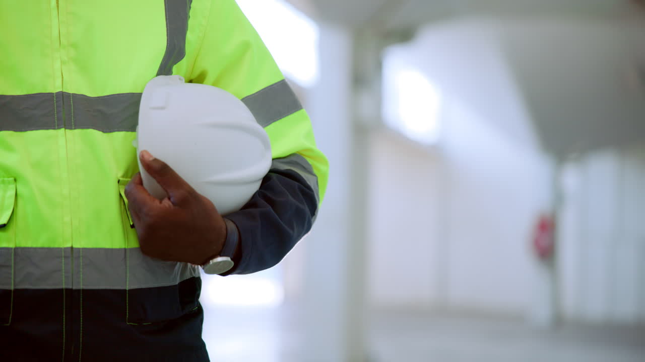 Construction worker holding hard hat