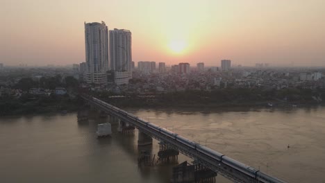 Train-running-on-the-bridge-over-the-river-in-the-morning-dawn