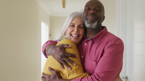 Portrait-of-happy-senior-diverse-couple-embracing