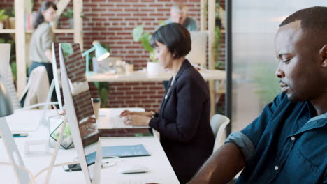 black man, computer and coworking workplace